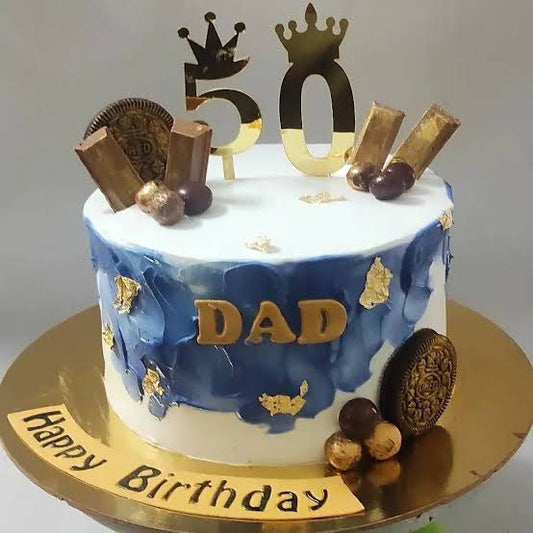 Blue and white birthday cake with gold accents and crown toppers